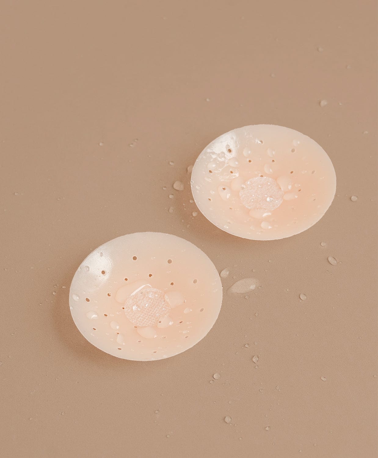 Nipple covers on brown background.