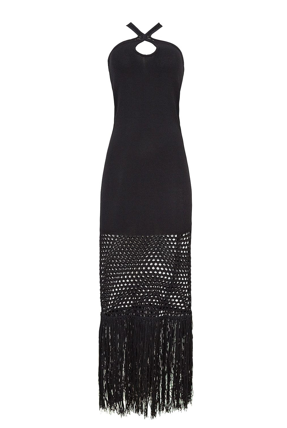 A black full length coverup dress with stitching details and fringe. Featured against a white wall background.