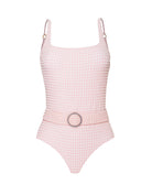 A light pink textured one piece swimsuit against a white wall.