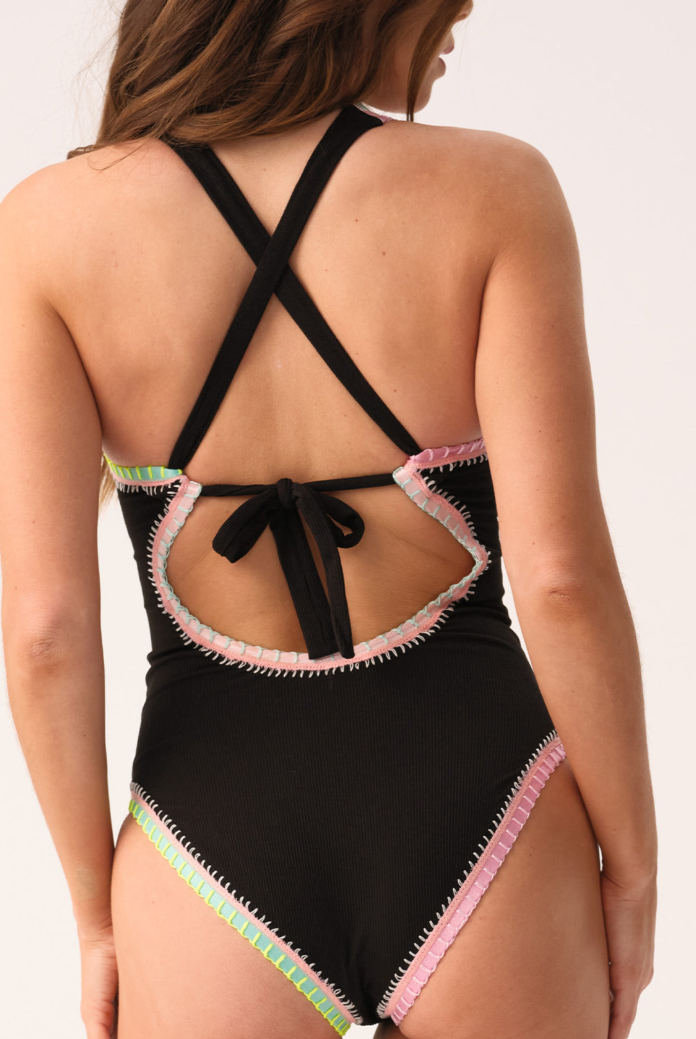 Black one-piece swimsuit with colorful trim on a white background