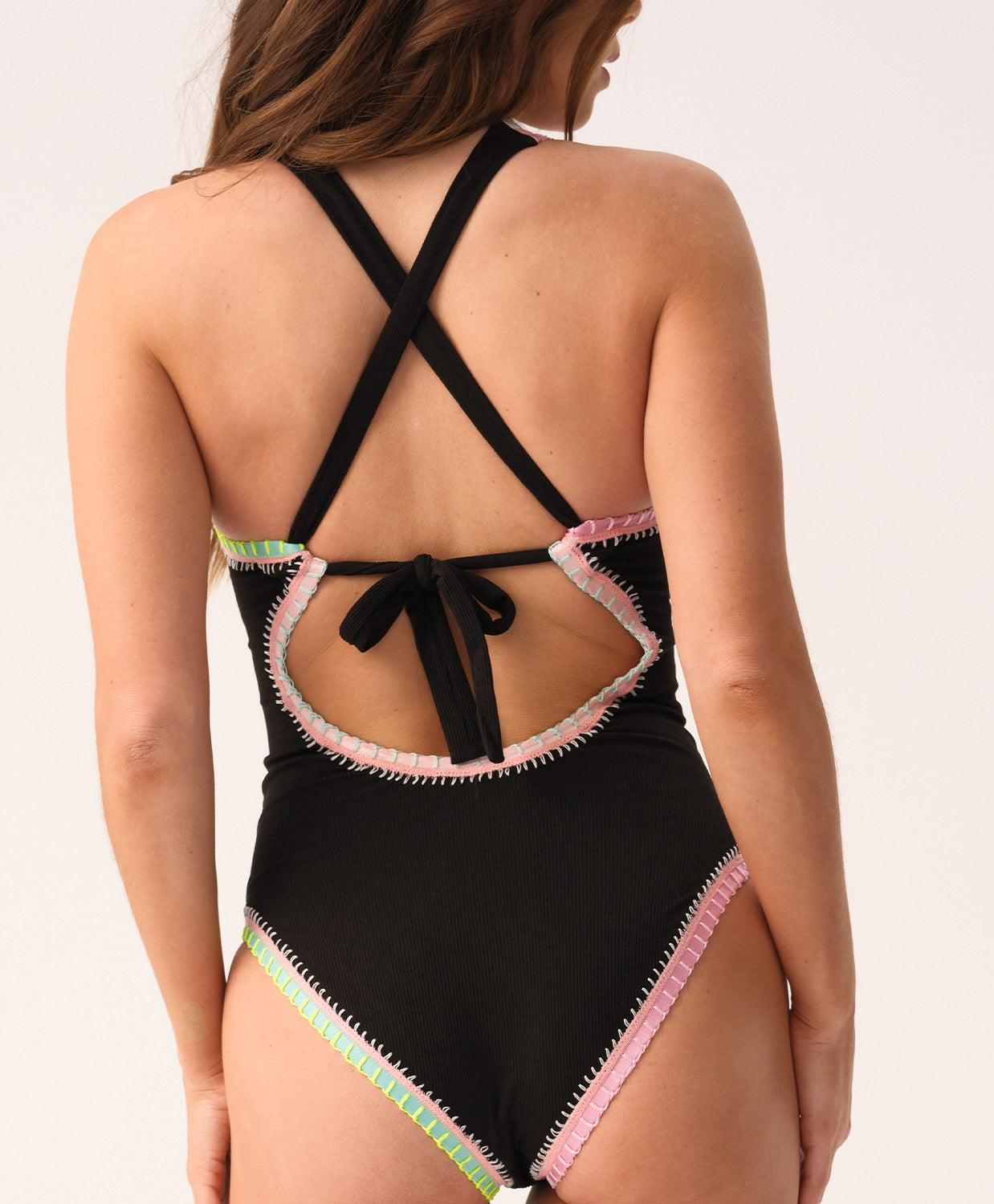 Black one-piece swimsuit with colorful trim on a white background