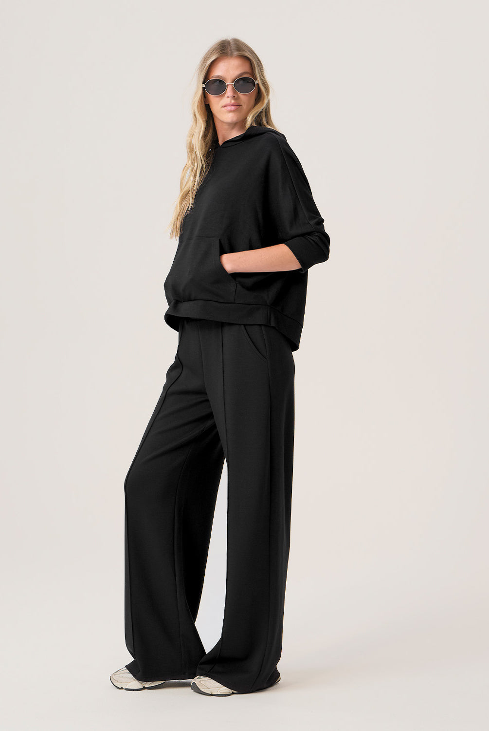 Woman wearing a black outfit on a white background