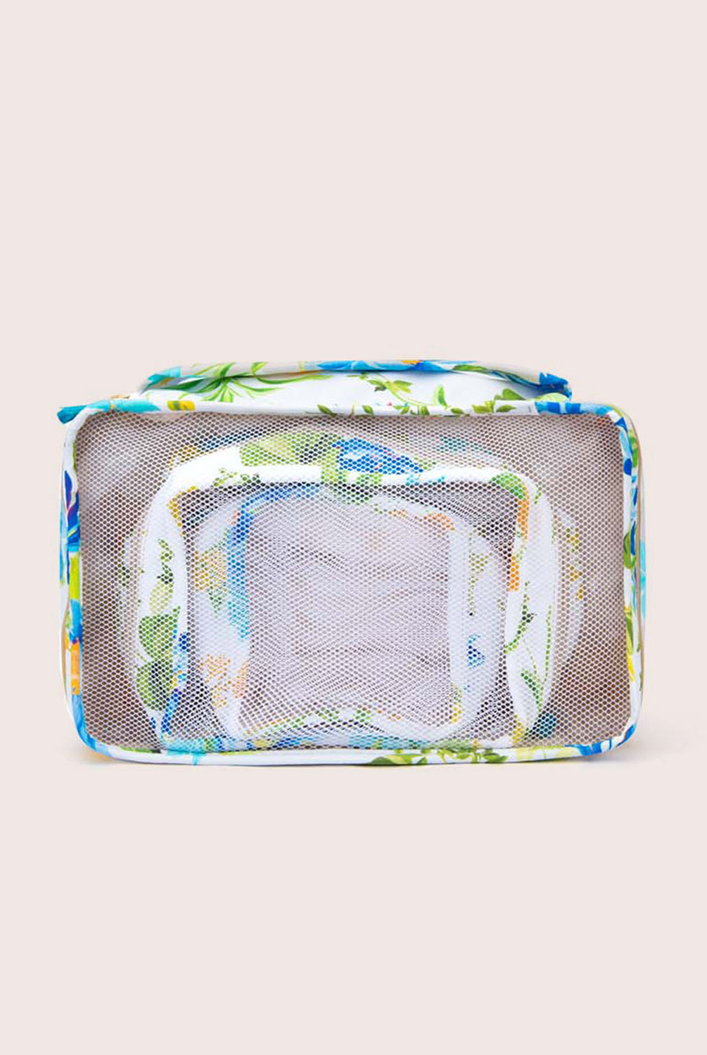 Packing cubes with a floral print against a white wall.