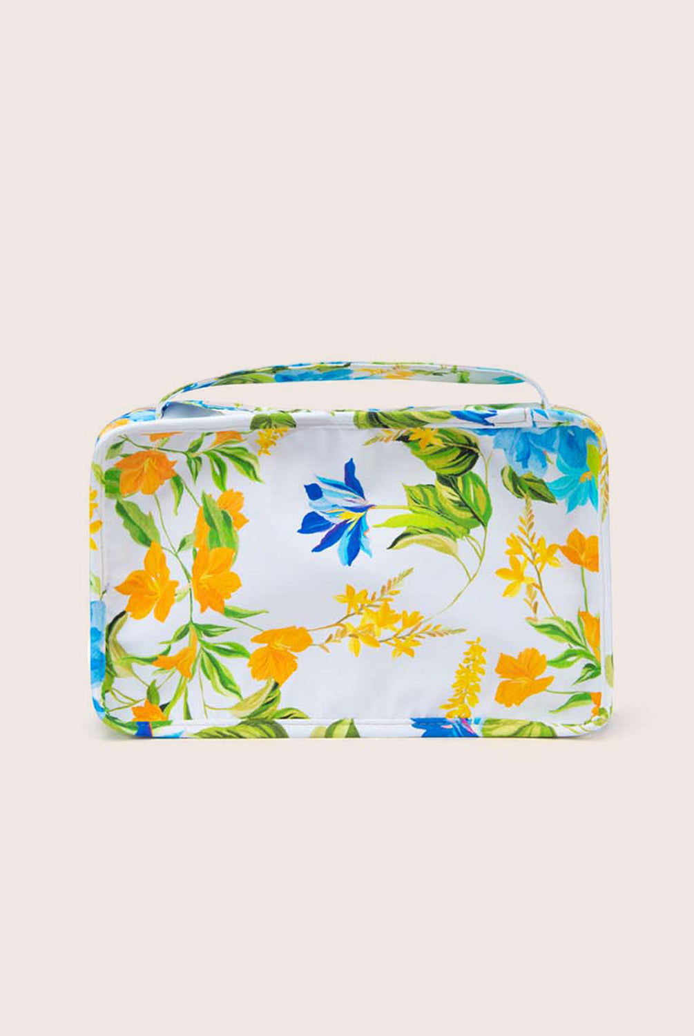 A packing cube with a floral print against a white wall.