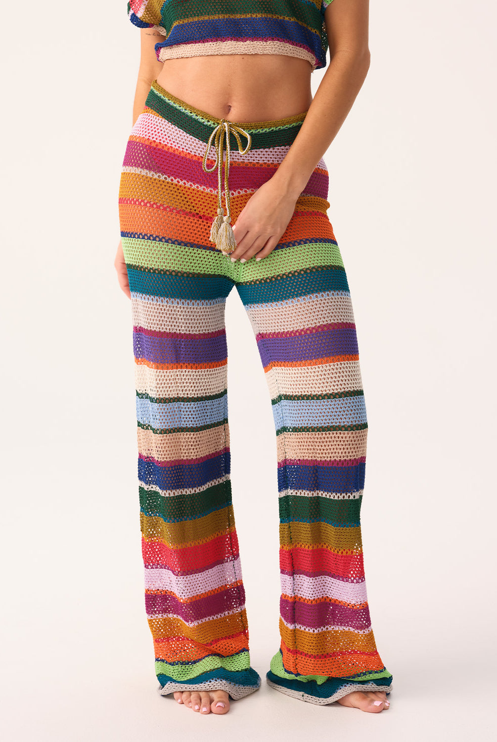 Colorful striped pants worn by a person on a white background