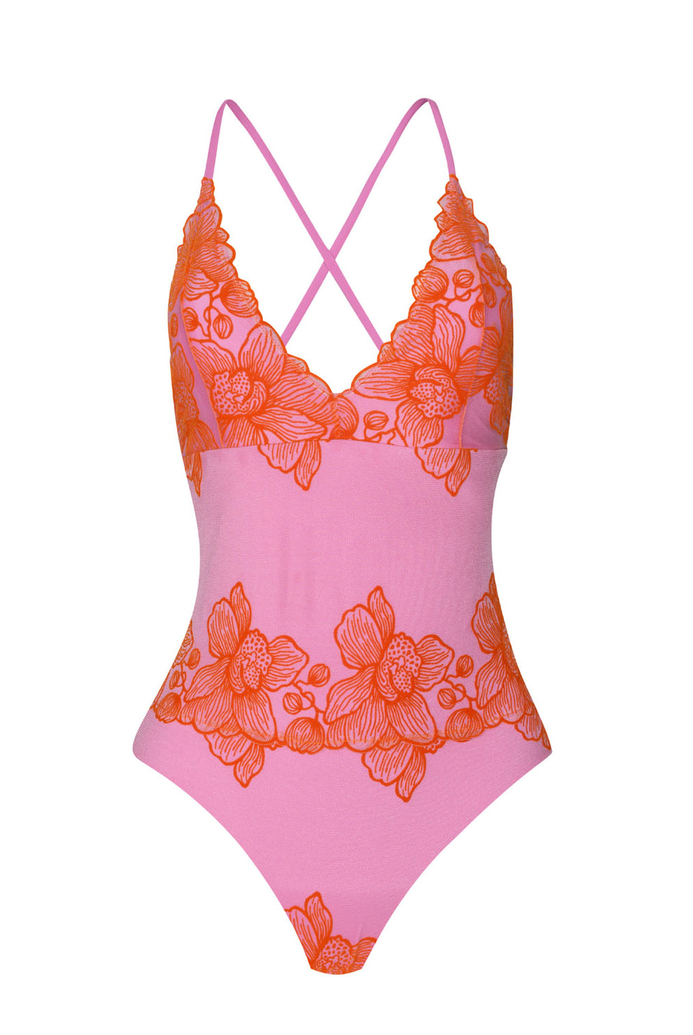 A pink one piece swimsuit with red floral accents against a white wall.