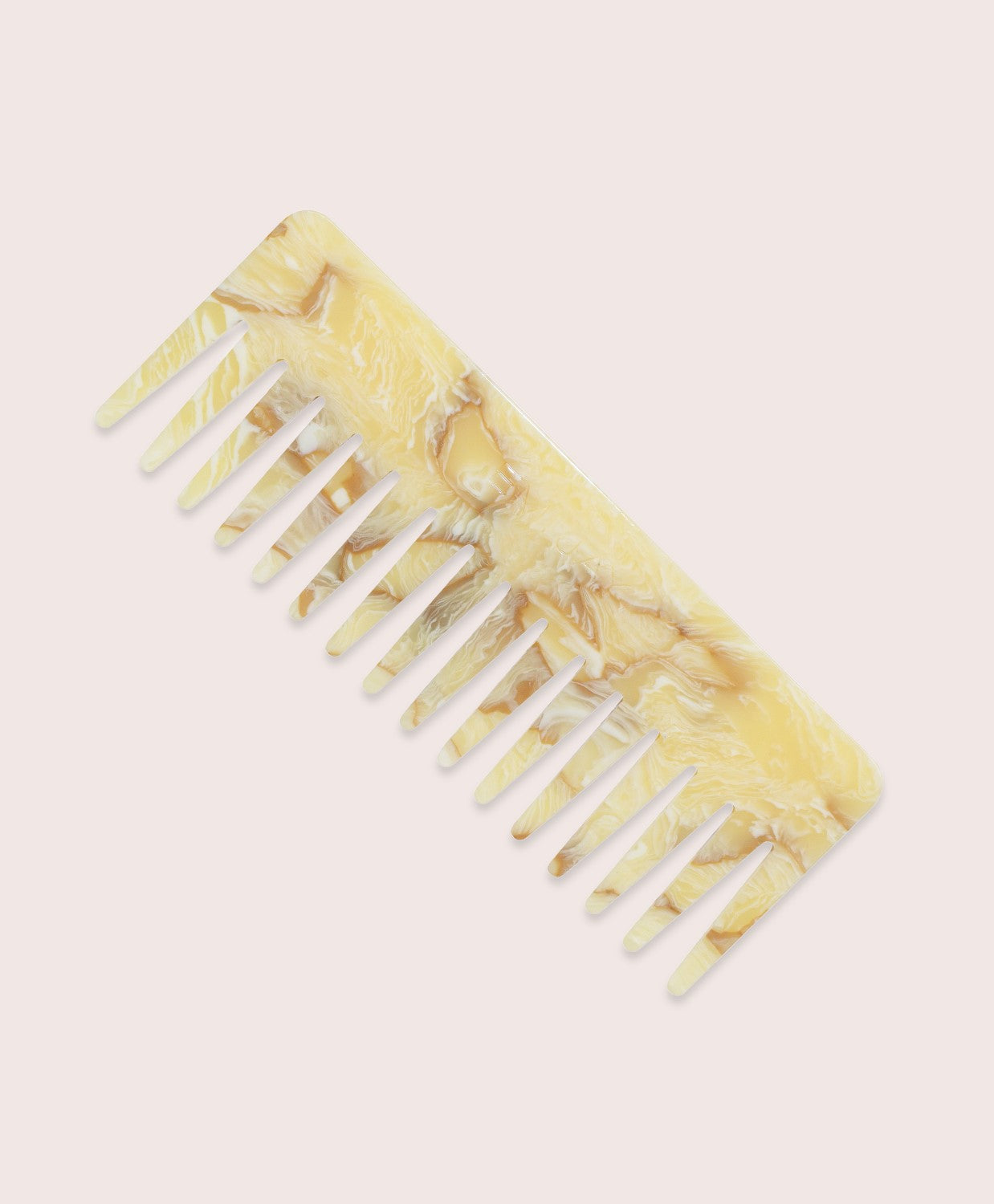 A yellow comb against a white wall.