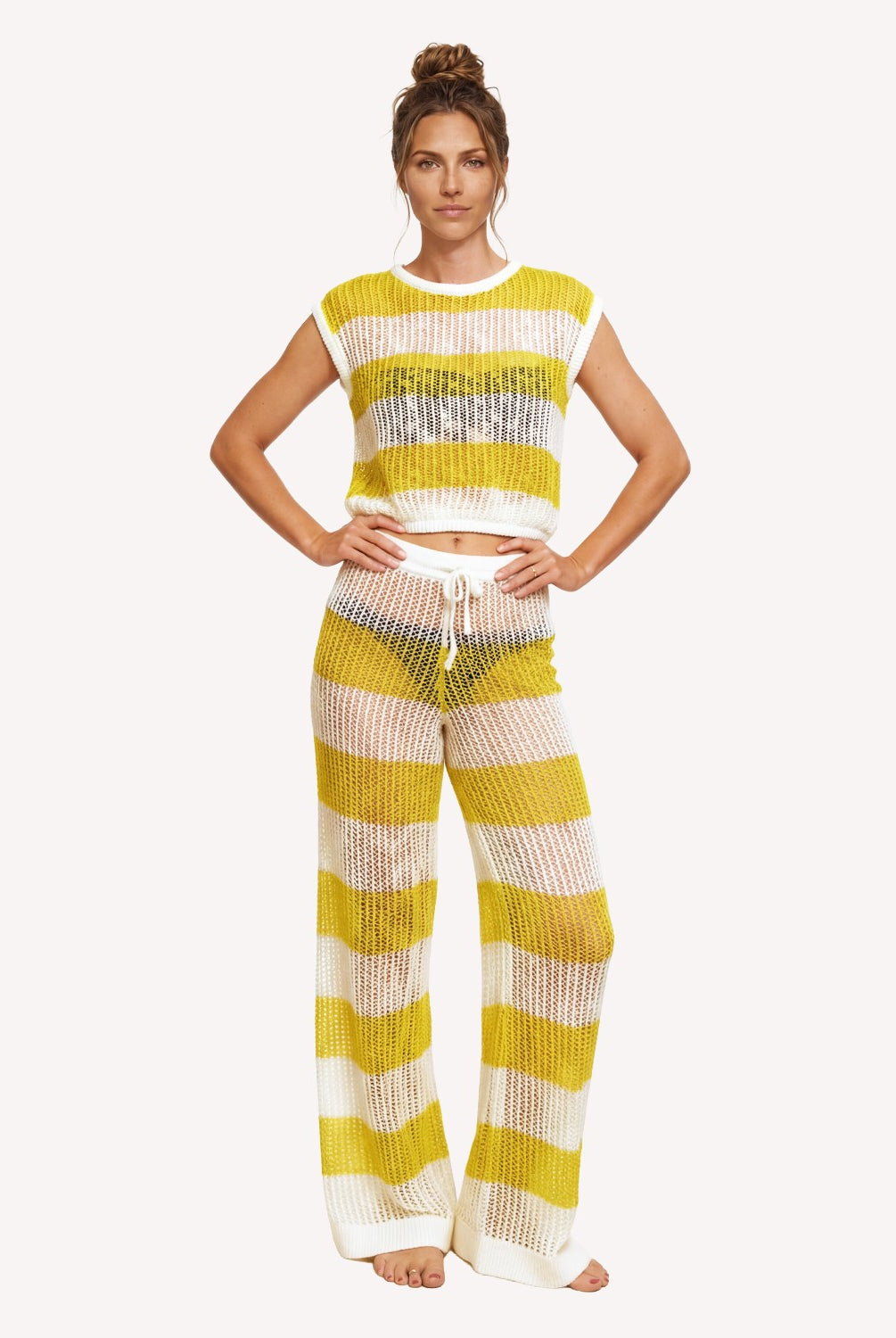Woman wearing a yellow and white striped outfit on a white background