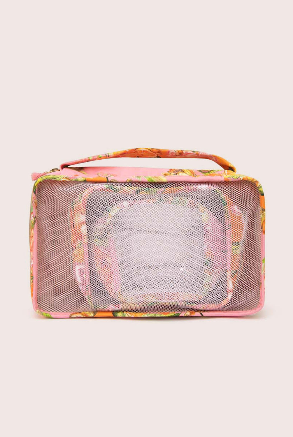 Packing cubes with an orange floral print against a white wall.