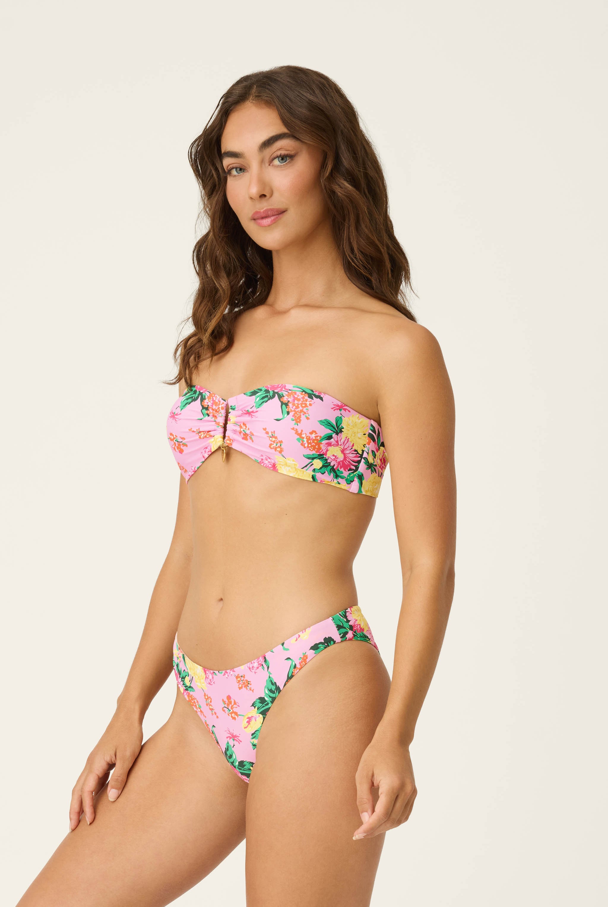 Dahlia Detail Bandeau bikini – strapless with bold florals, 24K gold embellishments, and detachable heart charm.