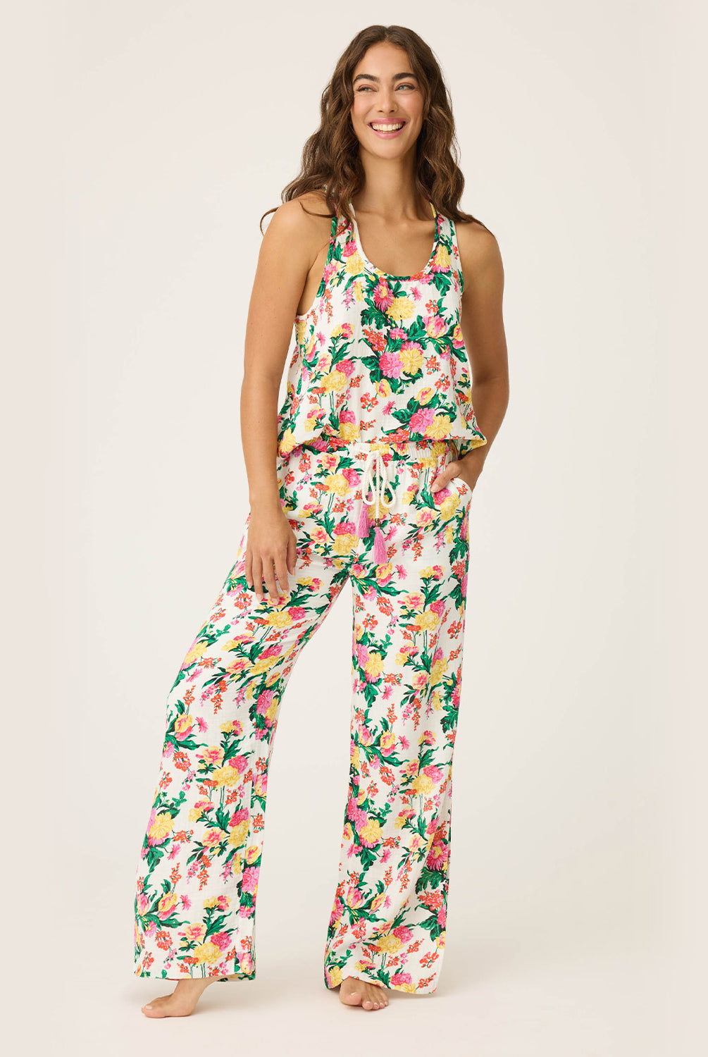 Dahlia Racerback Tank – lightweight tropical floral tank with scoop neckline and airy winged racerback, offering a relaxed, comfortable fit ideal for lounging or vacation mornings, styled with matching wide-leg pants.