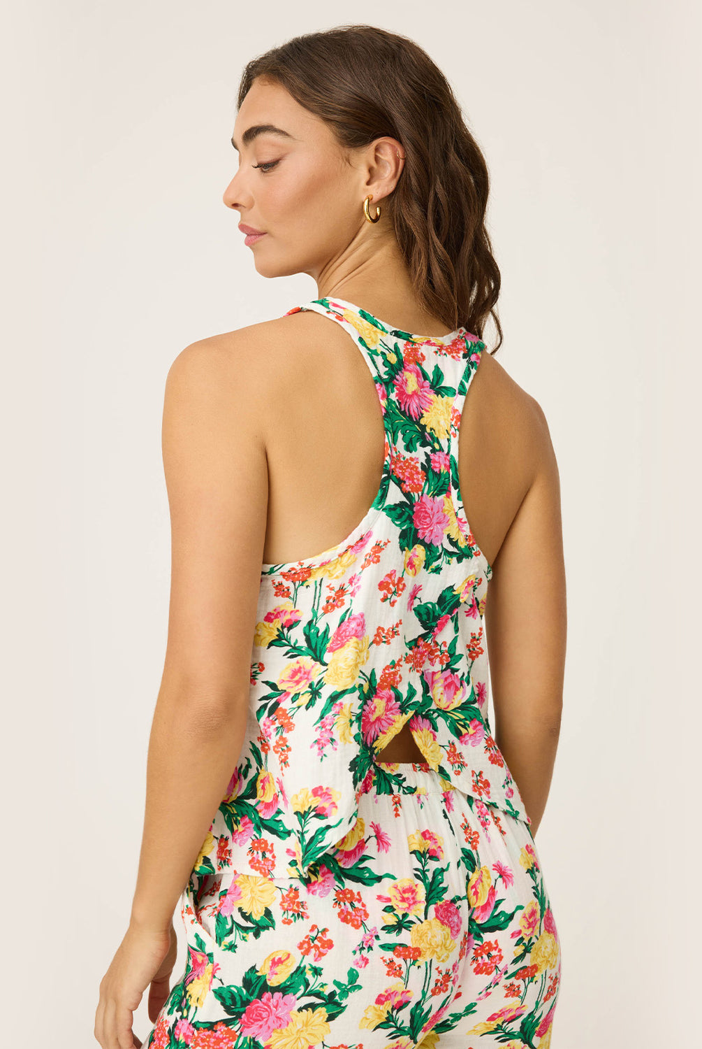 Dahlia Racerback Tank – lightweight tropical floral tank with scoop neckline and airy winged racerback, offering a relaxed, comfortable fit ideal for lounging or vacation mornings, styled with matching wide-leg pants.