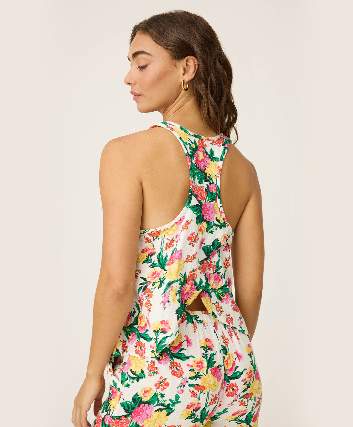 Dahlia Racerback Tank – lightweight tropical floral tank with scoop neckline and airy winged racerback, offering a relaxed, comfortable fit ideal for lounging or vacation mornings, styled with matching wide-leg pants.