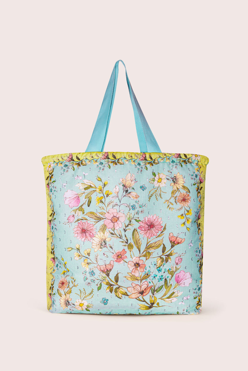 Floral tote bag with blue straps on a plain background