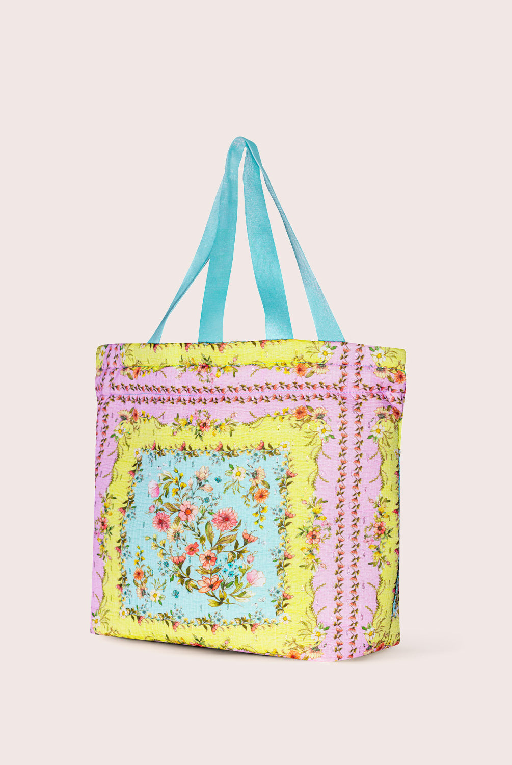 Colorful tote bag with floral design on a plain background