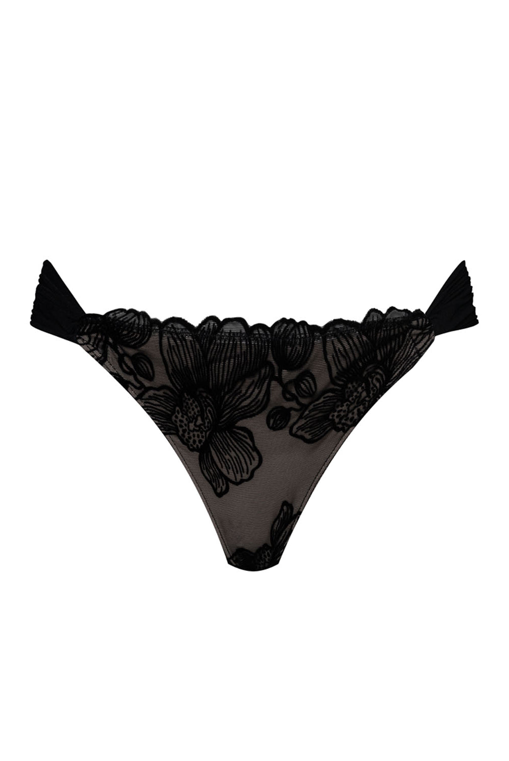 A black bikini bottom with flower details against a white wall.