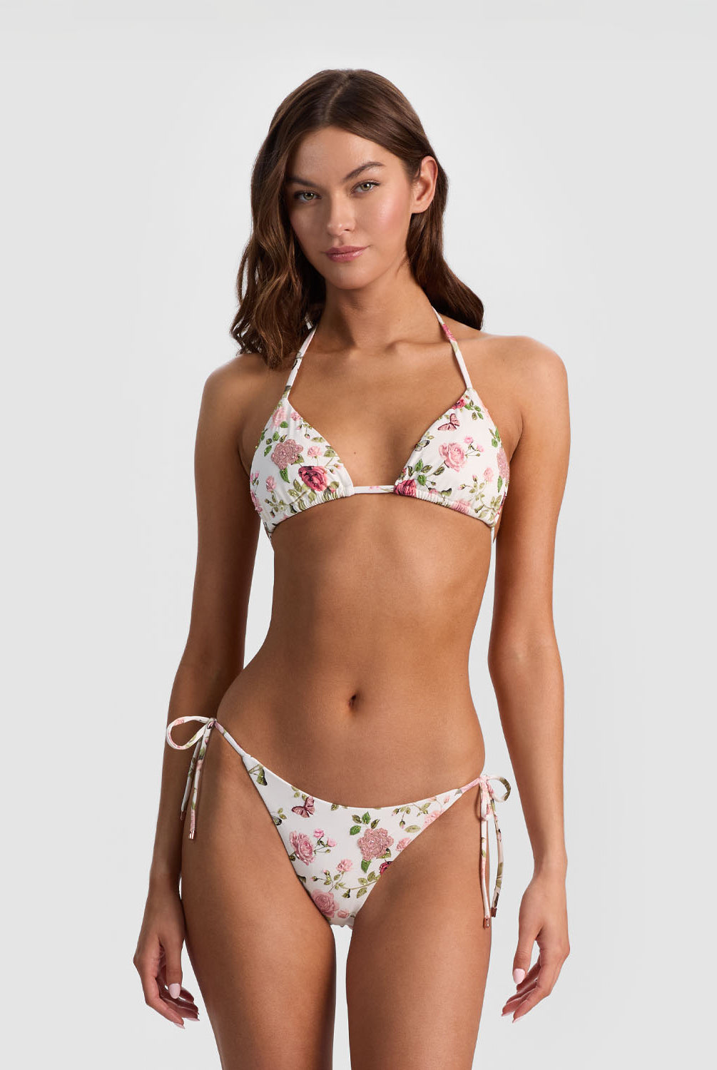 Woman wearing a floral bikini set on a white background