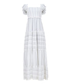 A long white dress against a white wall.