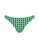 A blue and green checkered bikini bottom in front of a white wall.