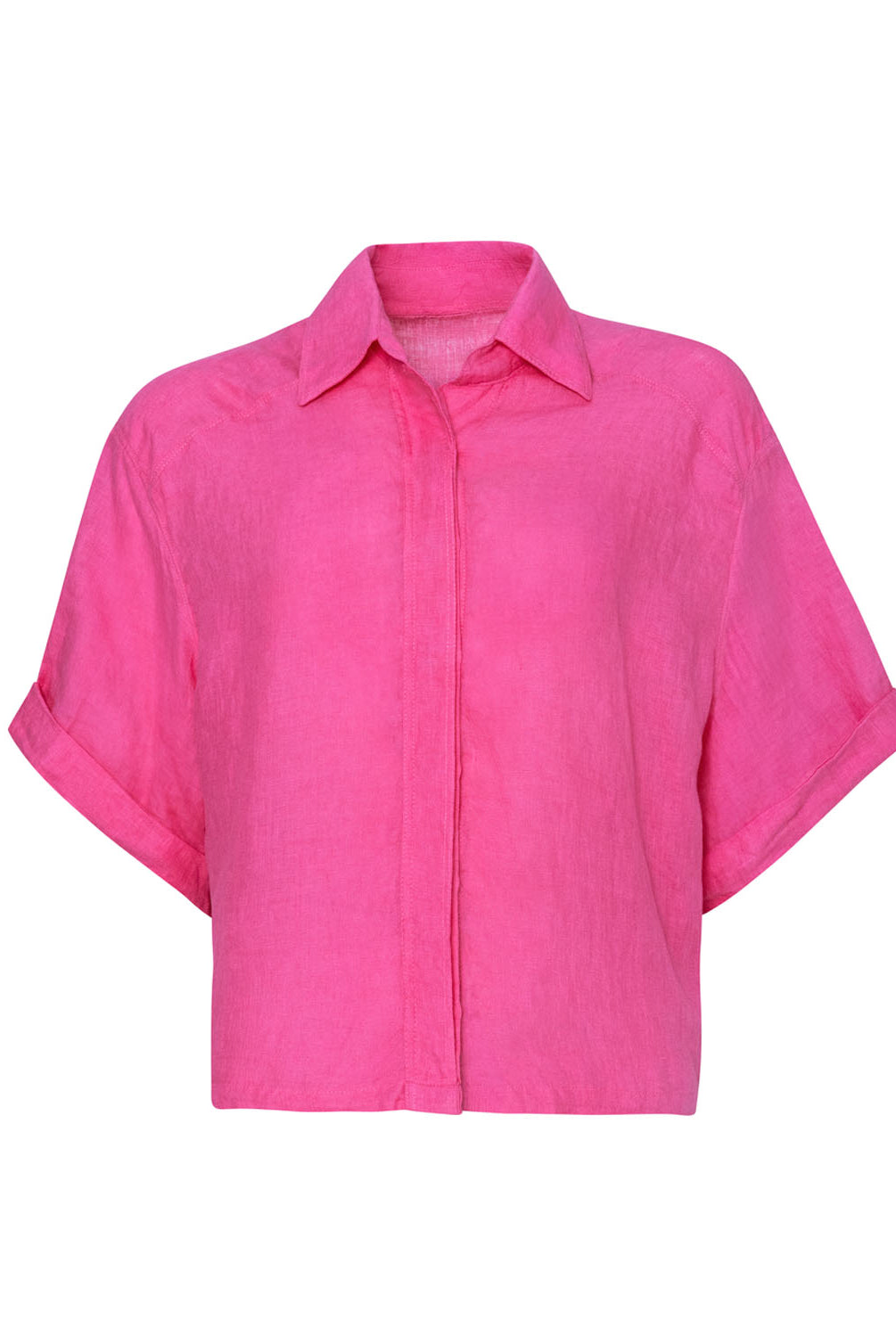 A pink linen shirt against a white wall.