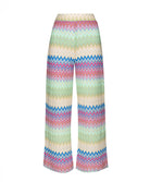 Long striped pants against a white wall.