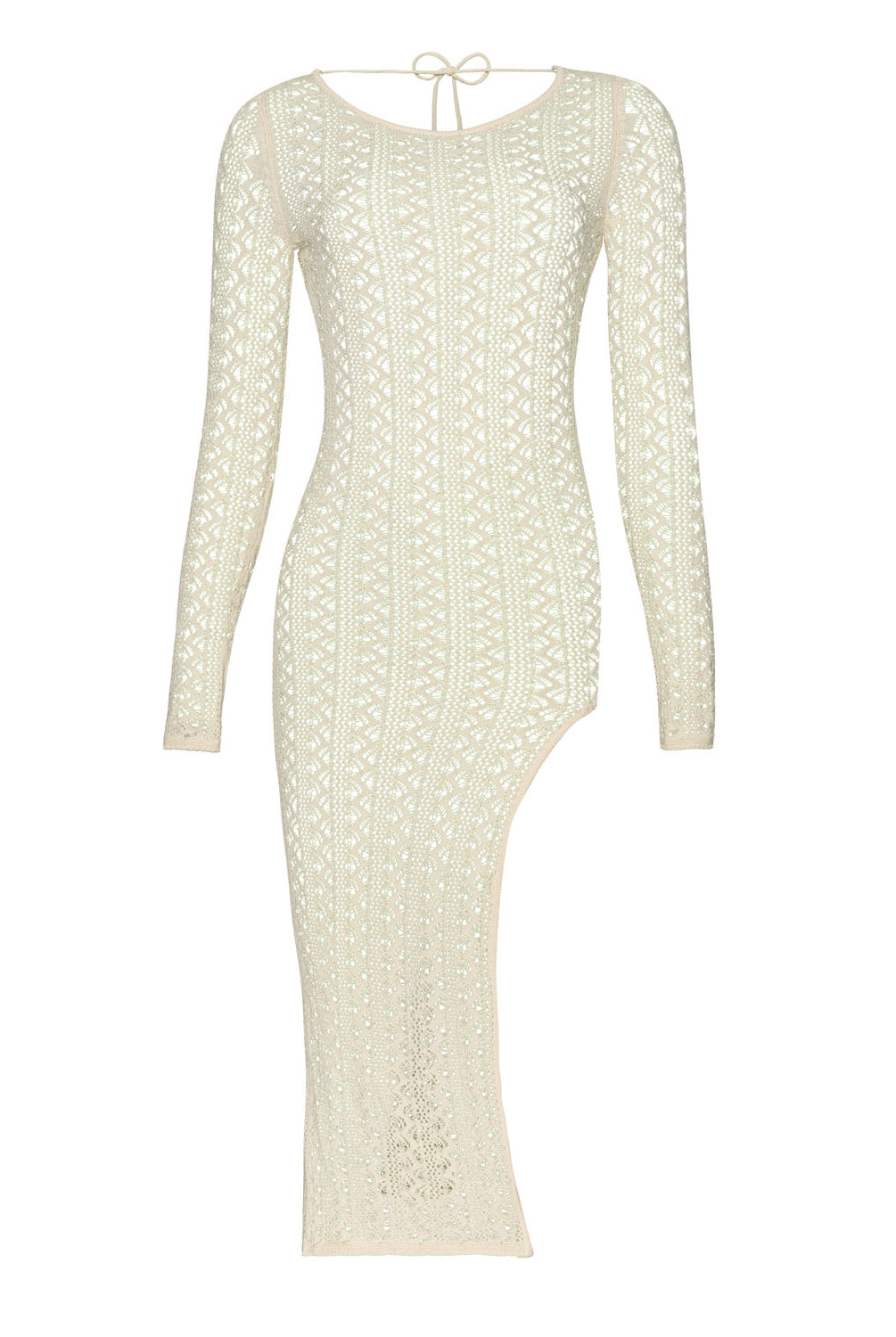 A long sleeve ivory dress with crochet details against a white wall.