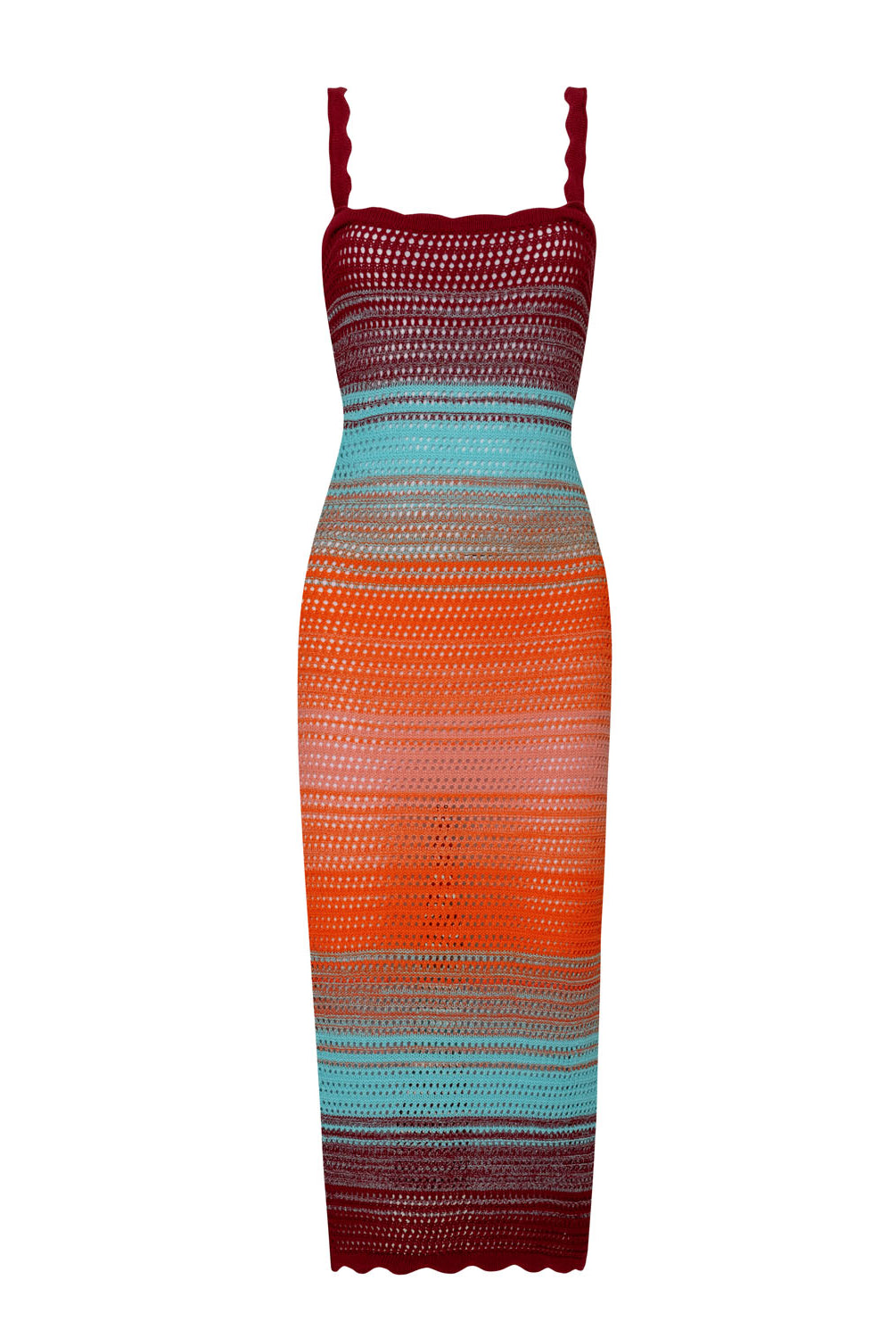 A midi length knit dress against a white wall.