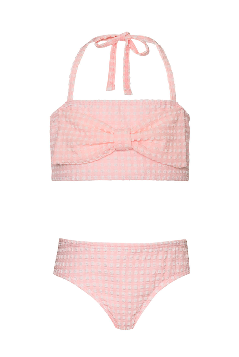 A light pink kids bikini with a bow against a white wall.