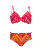 A pink and orange striped kids bikini against a white wall.