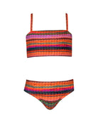 A striped kids bikini against a white wall.