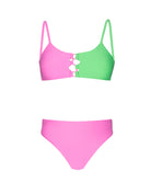 A pink and green bikini against a white wall.