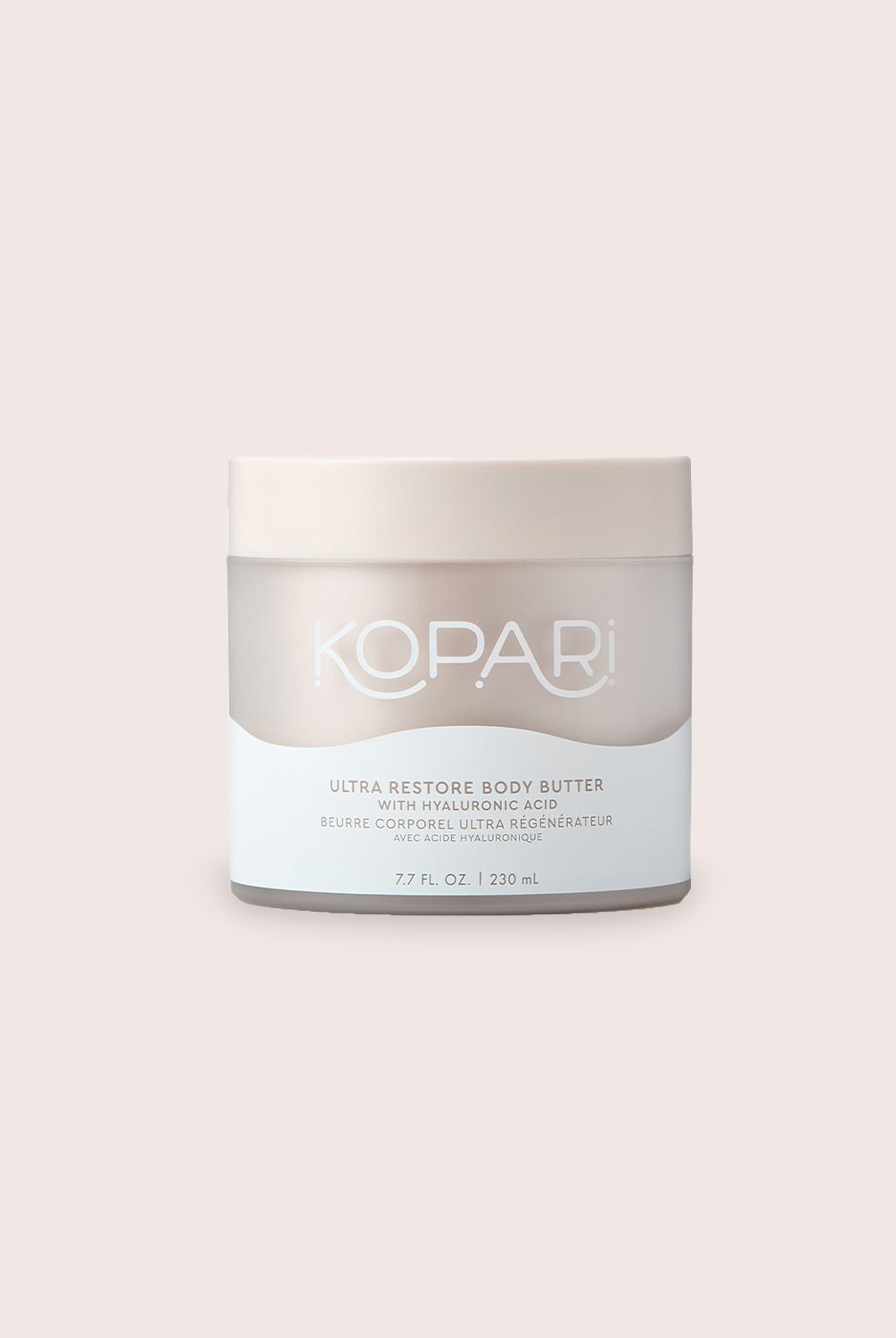 A jar of body lotion against a white wall.