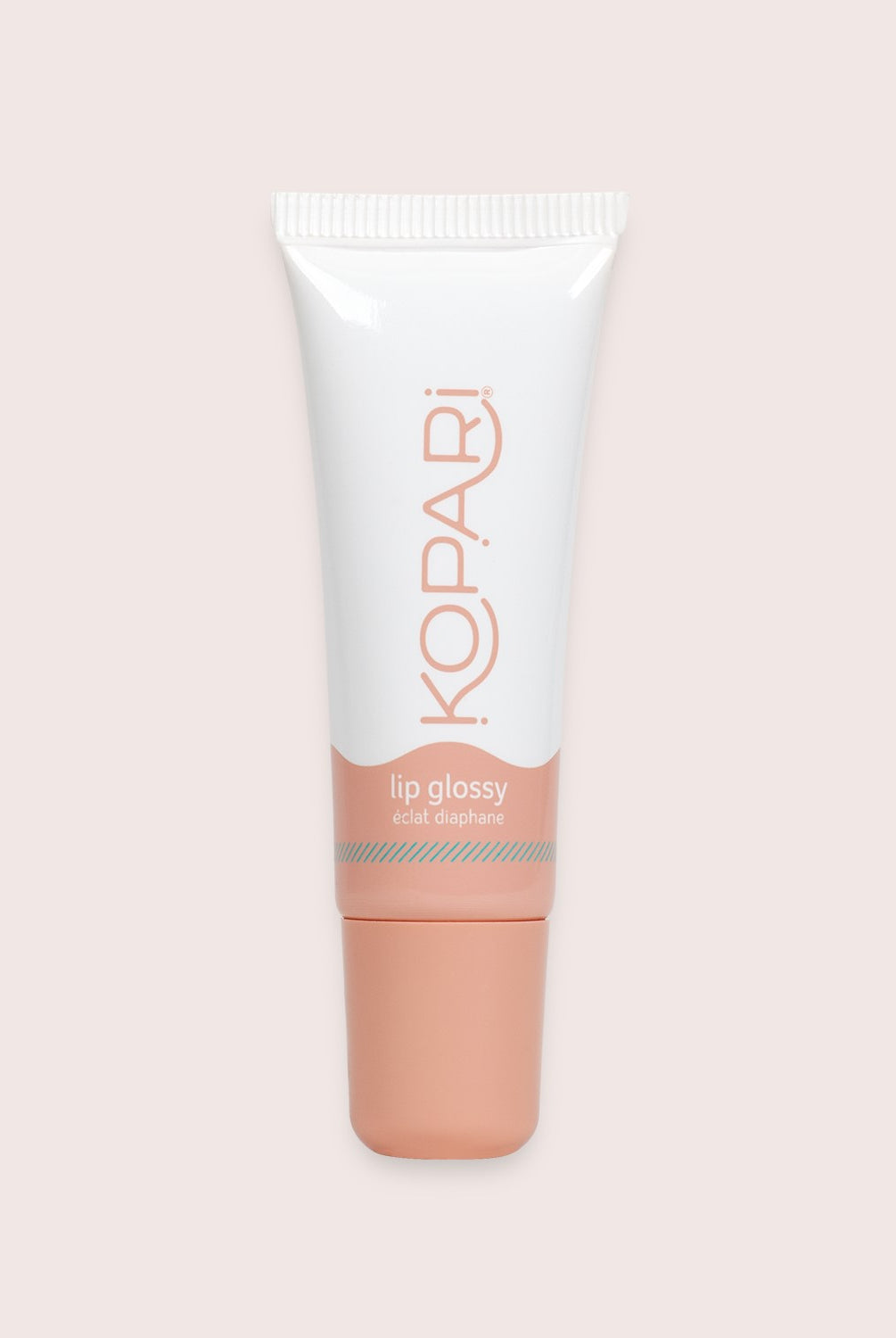 Pink lip gloss tube against a white wall.