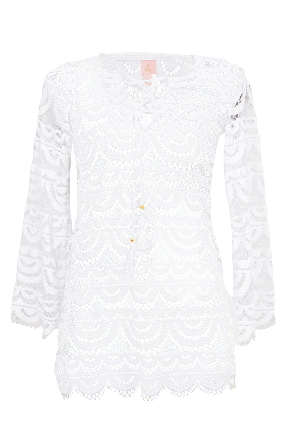 A white long sleeve lace cover up  dress against a white wall.