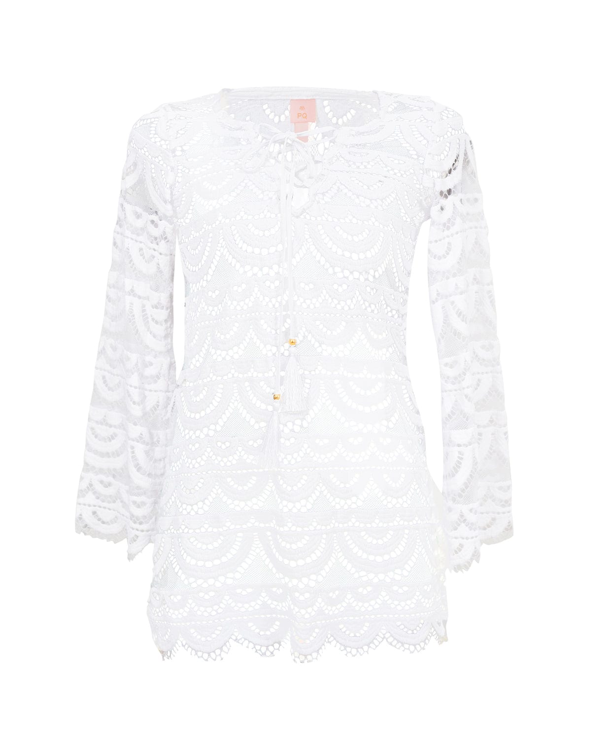 A white long sleeve lace cover up dress against a white wall.