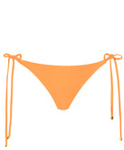 An orange bikini bottom against a white wall.