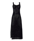 A black floor length dress against a white wall.