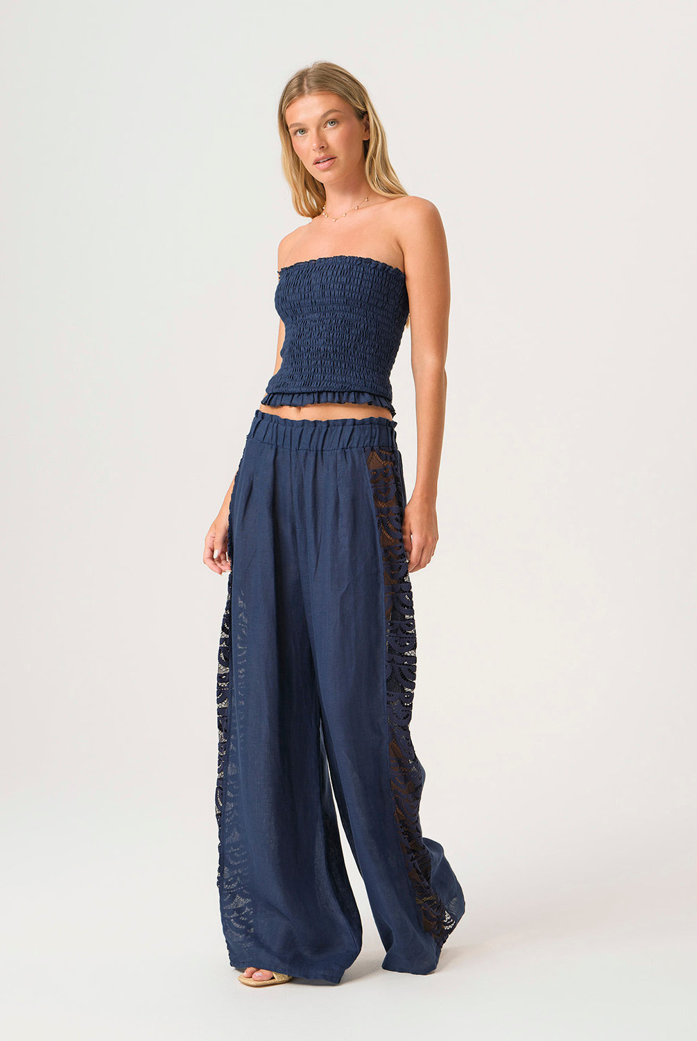 Navy Jace Lace Pant in airy navy linen with hand-cut lace side panels and a ruched waistband for a feminine, resort-ready look.