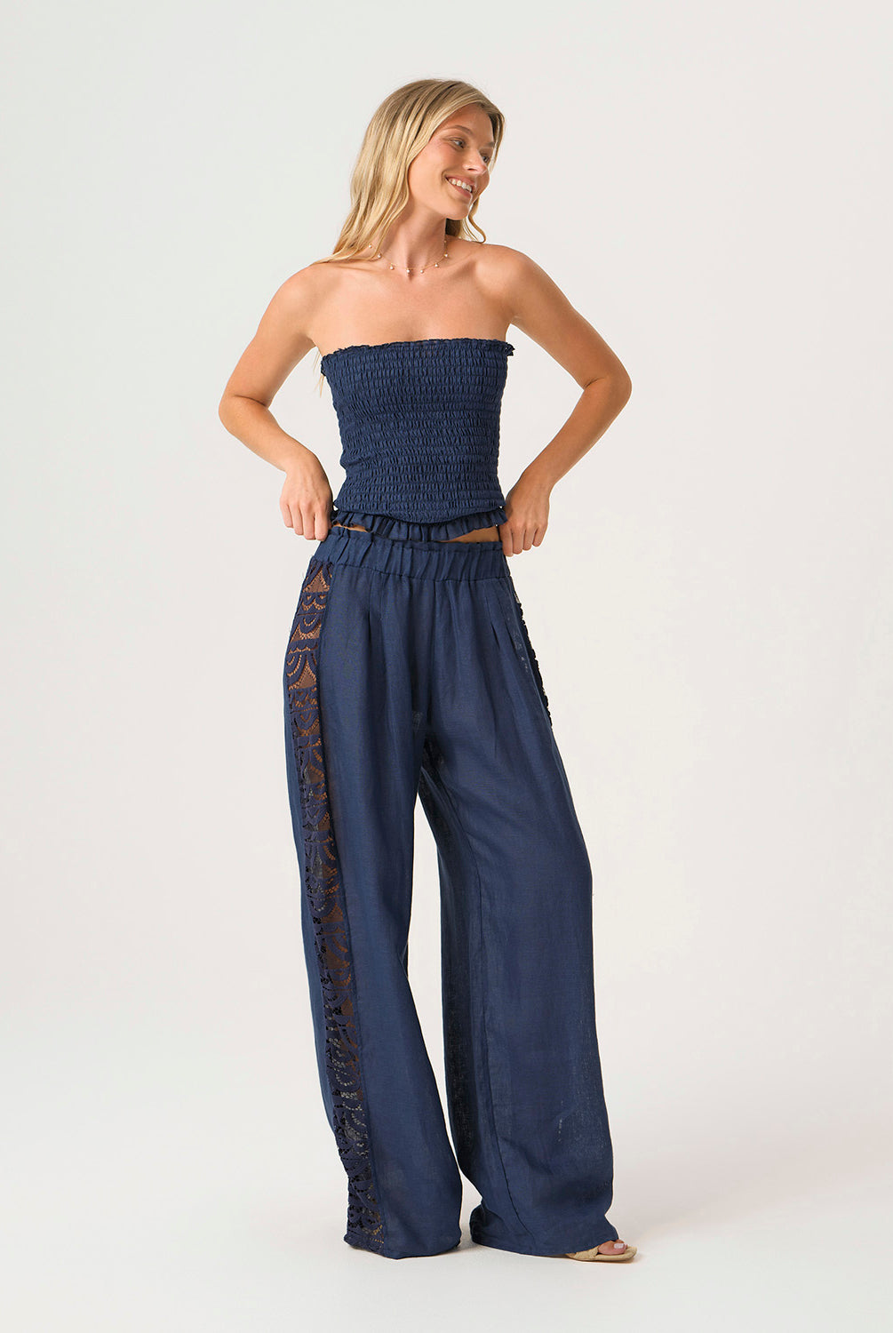 Navy Jace Lace Pant in airy navy linen with hand-cut lace side panels and a ruched waistband for a feminine, resort-ready look.