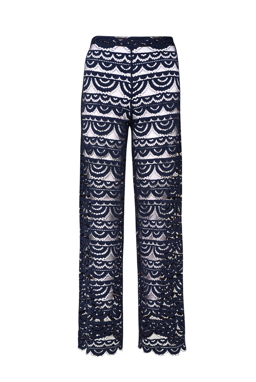 Long navy lace pants against  white wall.