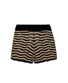 Tan and black striped shorts against a white wall.