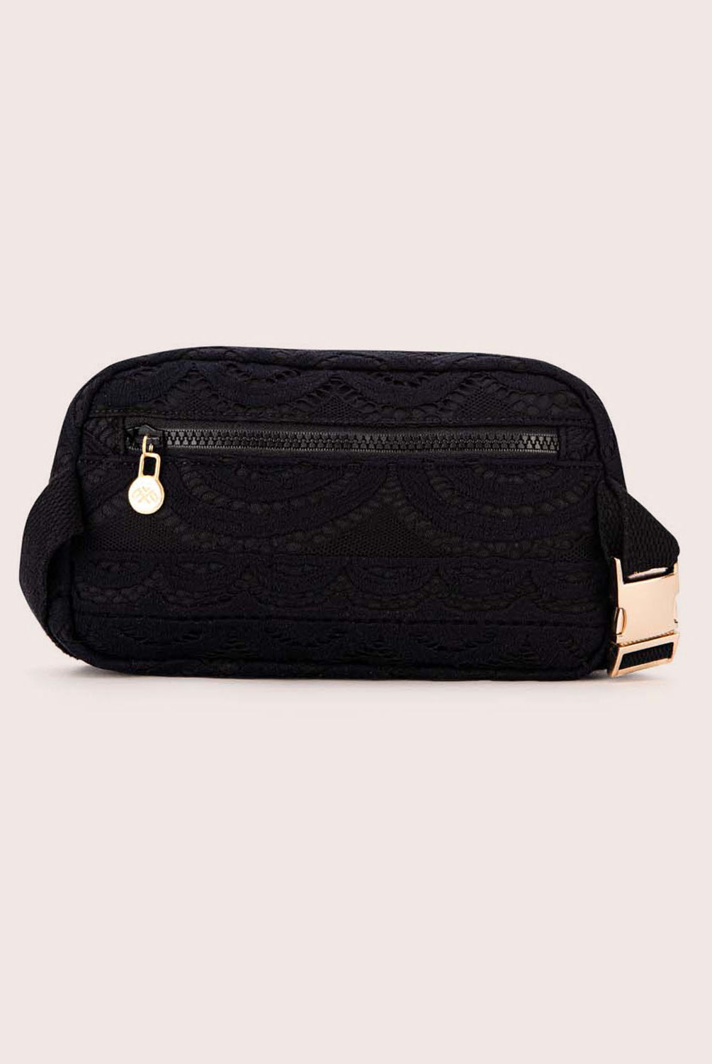 A black lace crossbody bag against a white wall.