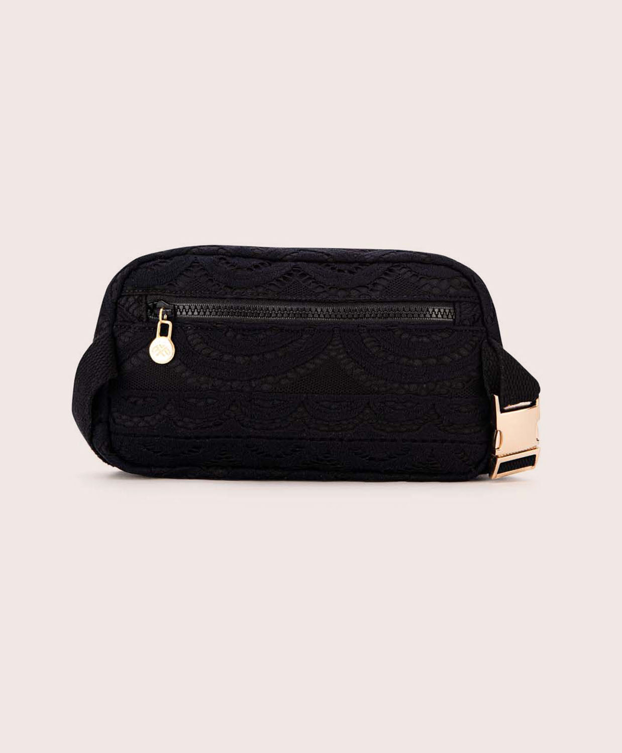 A black lace crossbody bag against a white wall.