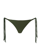 A green bikini bottom against a white wall.