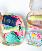 Three packing cubes with travel essentials packed inside.