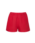 Red linen shorts against a white wall.