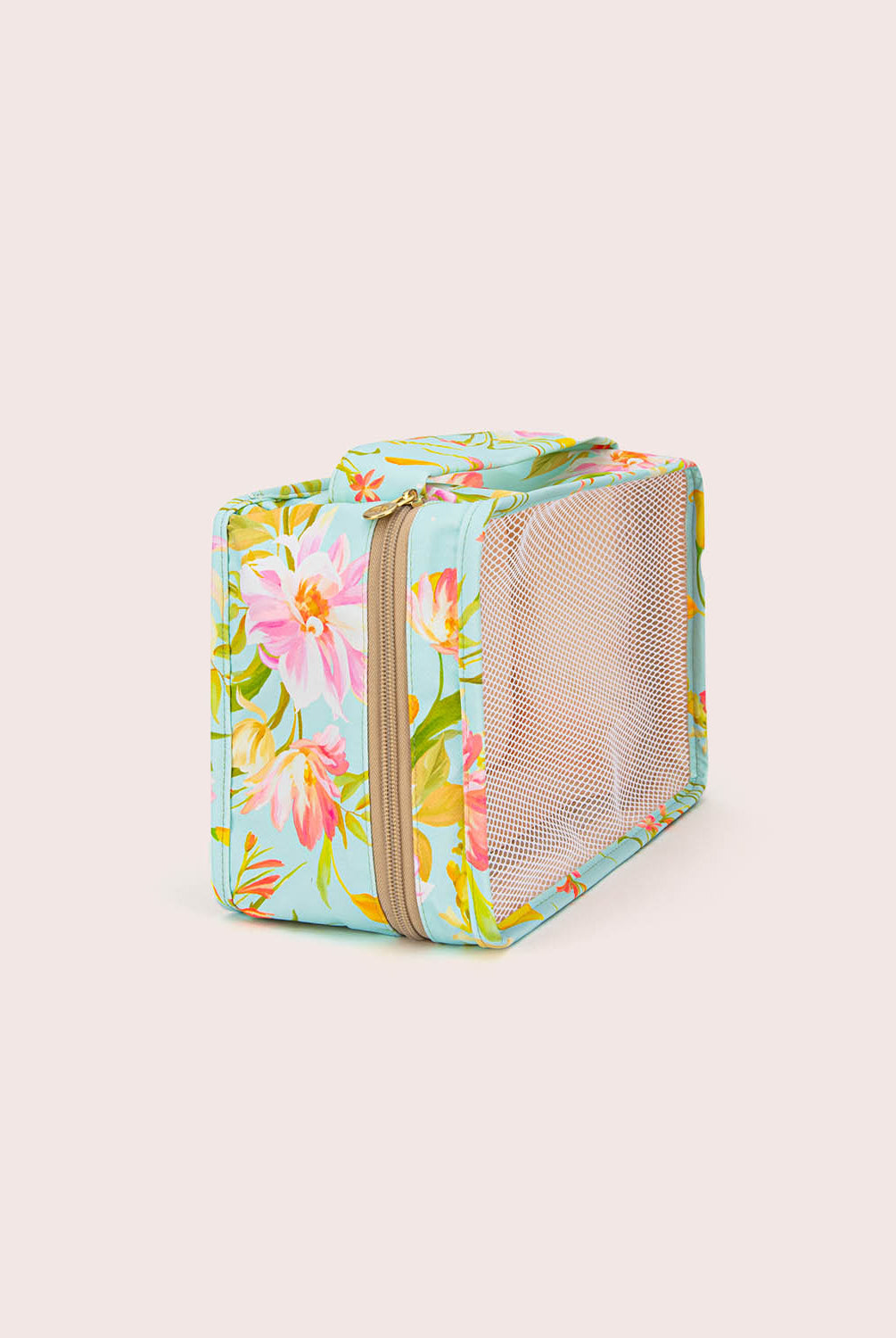 Floral-patterned packing cube with a mesh side on a light beige background