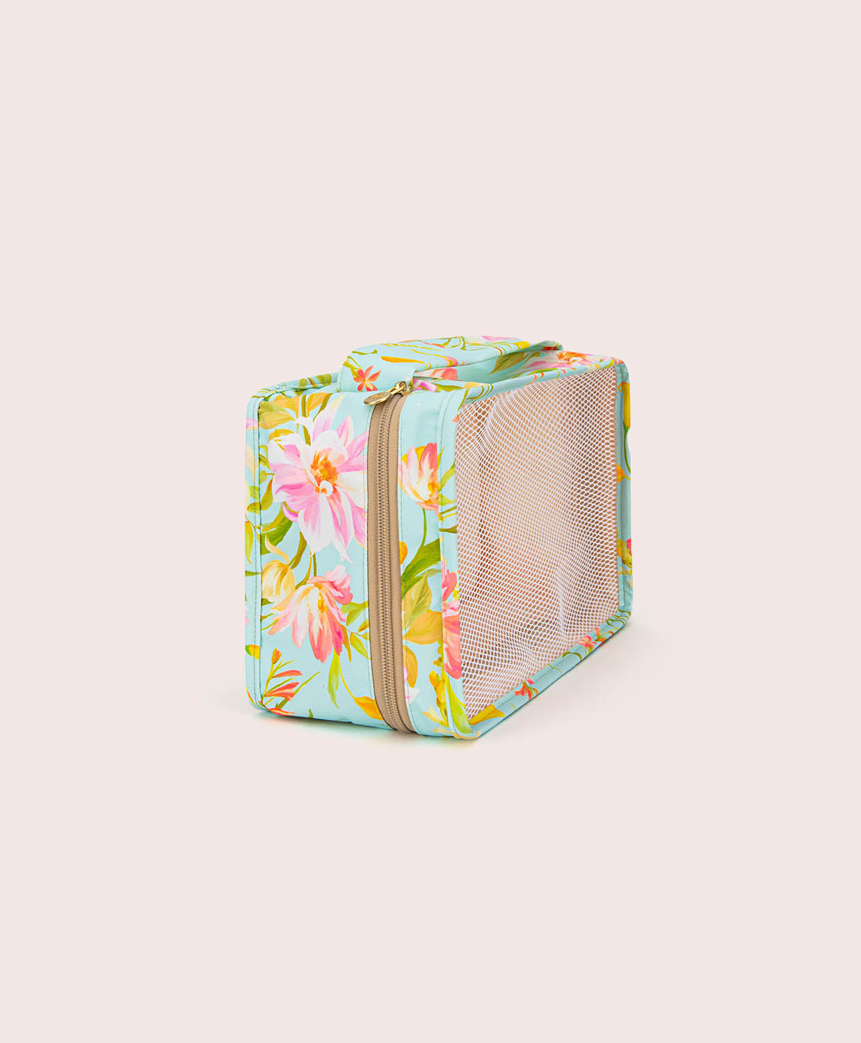 Floral-patterned packing cube with a mesh side on a light beige background