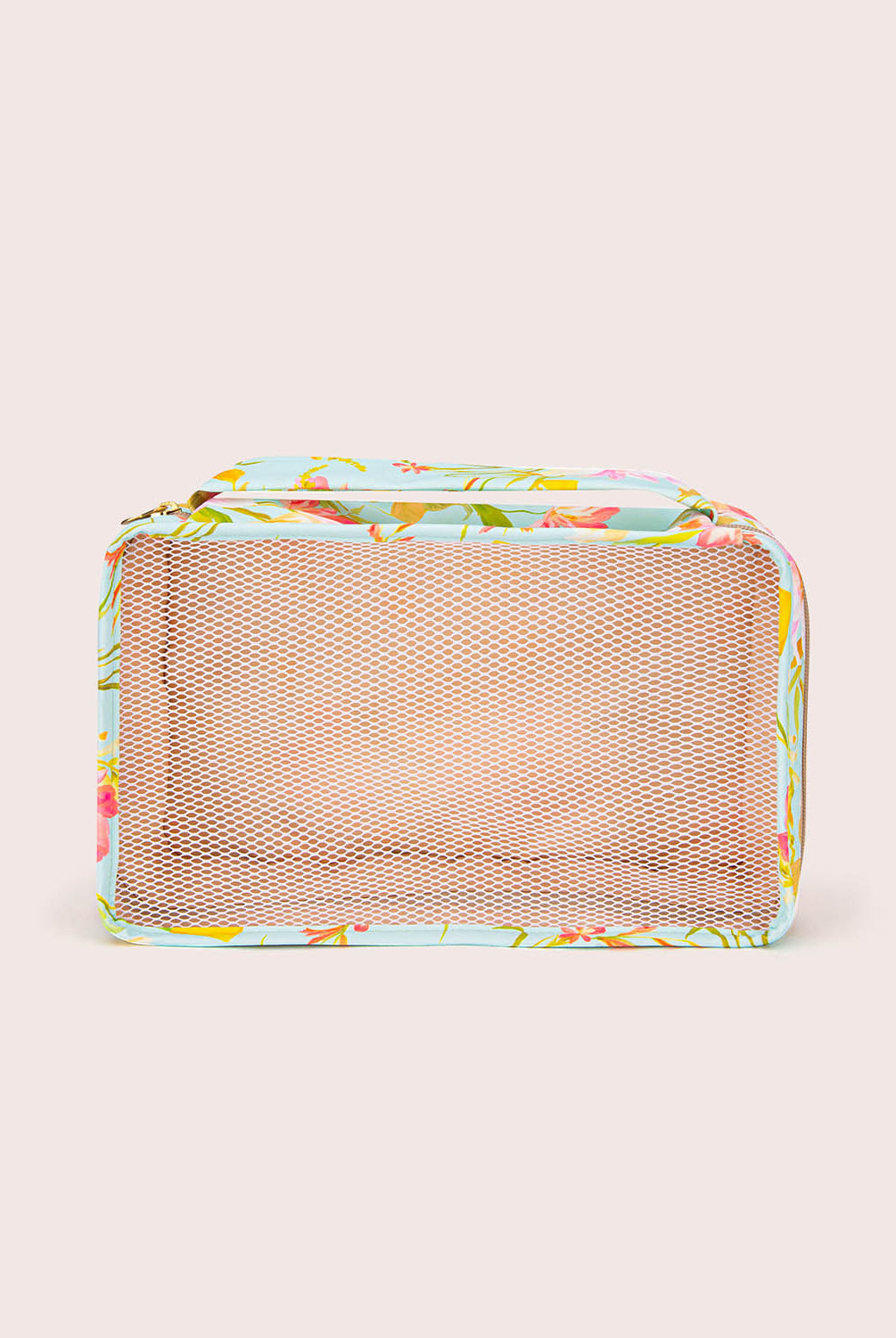 Rectangular mesh packing cube with floral pattern on a beige background