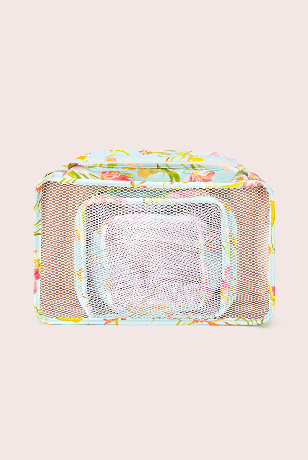 Multicolored mesh packing cube with floral pattern on a beige background